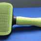 Green brush with button for easy cleaning